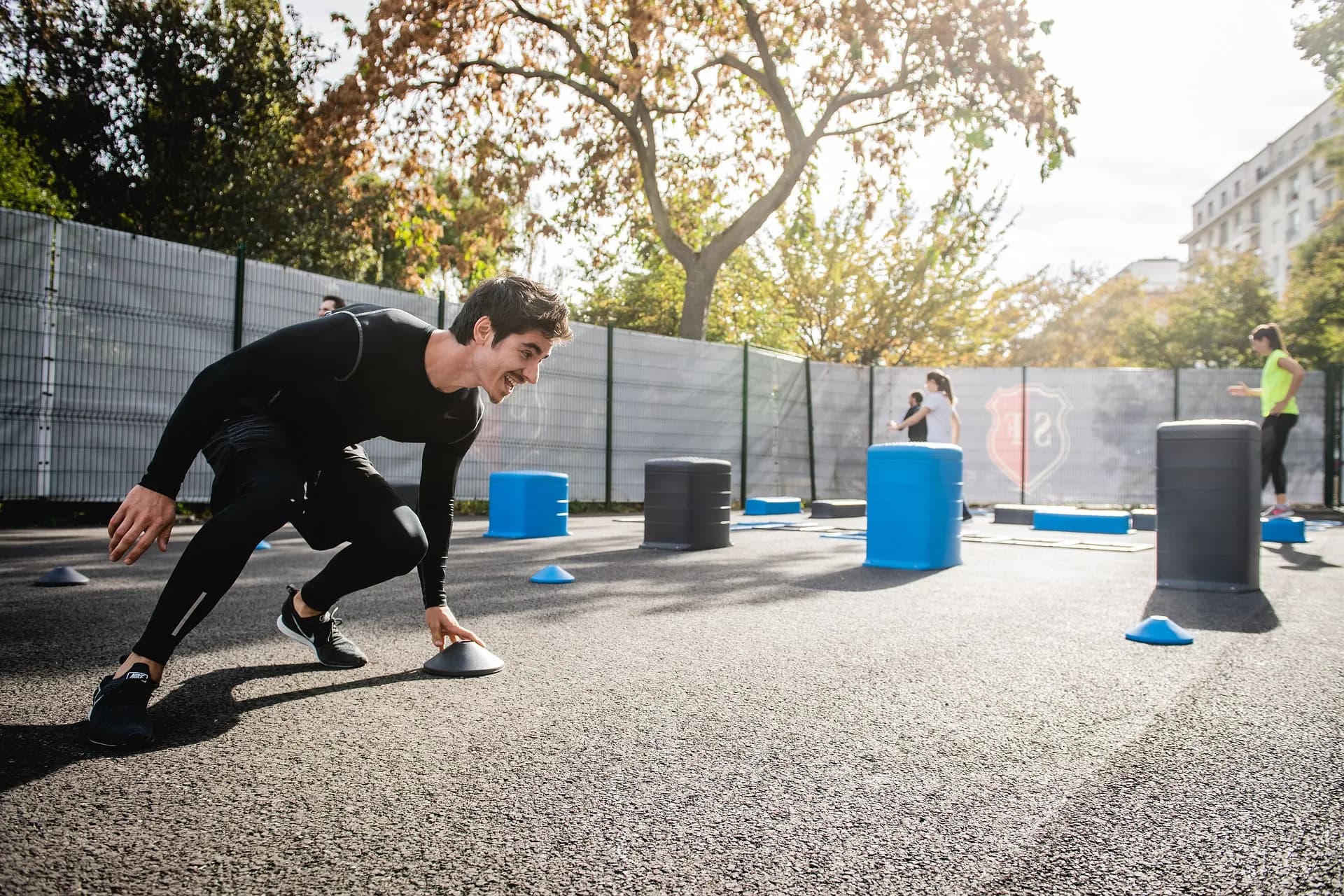 Client training with agility cones during an outdoor personal training session